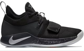 Black basketball shoes with a white speckled pattern on the midsole of the shoe and a white Nike swoosh at the base of the heel.