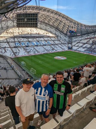 Declan's brother, dad and Declan posing for a photo from their seats in the Stade Velodrome in Marseille.