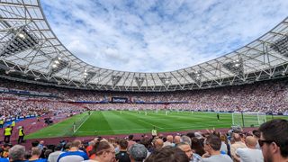 View of the pitch from the lower section of the Sir Trevor Brooking Stand inside the London Stadium. West Ham and Brighton players are ready for kick-off.
