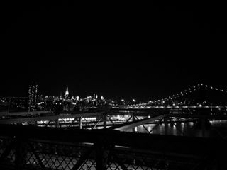 Brooklyn bridge with Manhattan in the distance. Black and white filter applied.