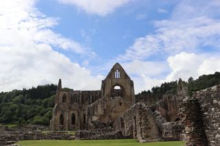 View of Tintern Abbey with ruins in the foreground.