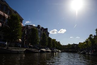 Sun shining onto some of the houses that line one of the canals in Amsterdam.